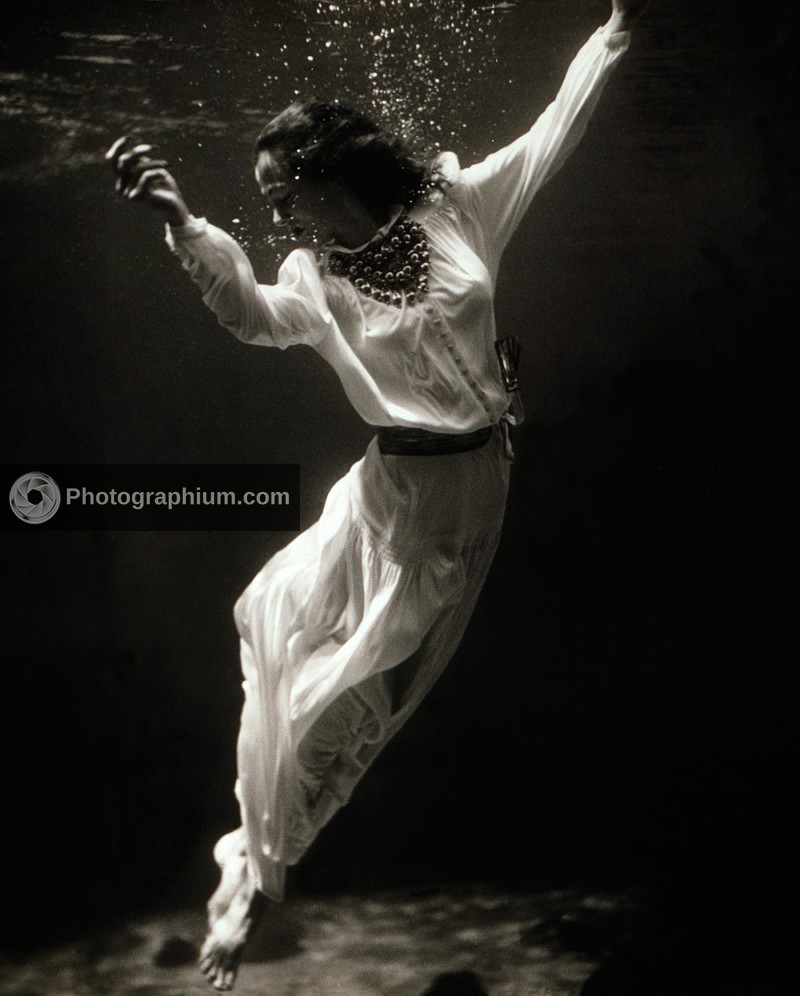Fashion model underwater in dolphin tank. Marineland, Florida. 1939