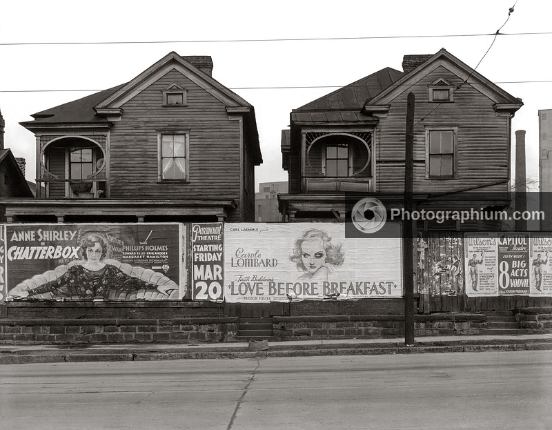 Houses with movie posters in foreground for Carole Lombard in Love Before Breakfast and Anne Shirley in Chatterbox. Atlanta, Georgia. 1936