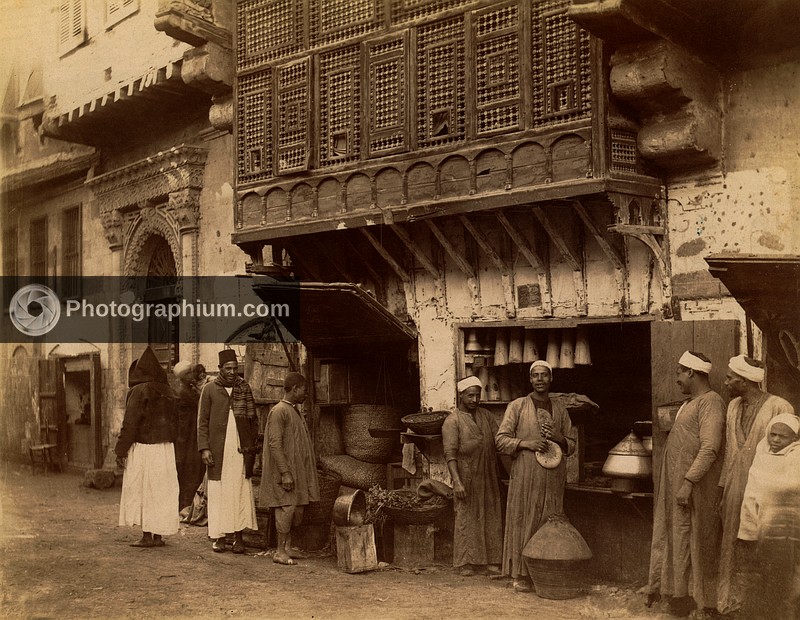 Men standing next to shop stall open to street. Egypt. 1860-1870