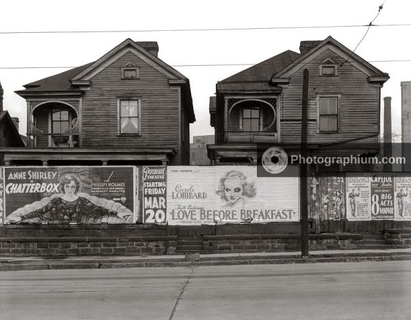 Houses with movie posters in foreground for Carole Lombard in Love Before Breakfast and Anne Shirley in Chatterbox. Atlanta, Georgia. 1936