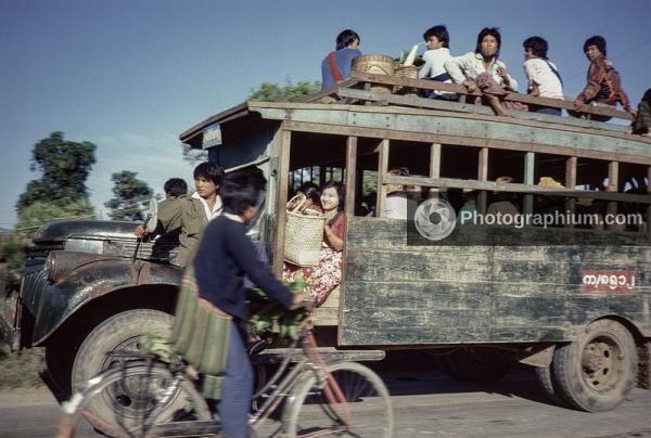 Rural bus with a weathered metal front and a traditional wooden body. Burma (Myanmar). 1986